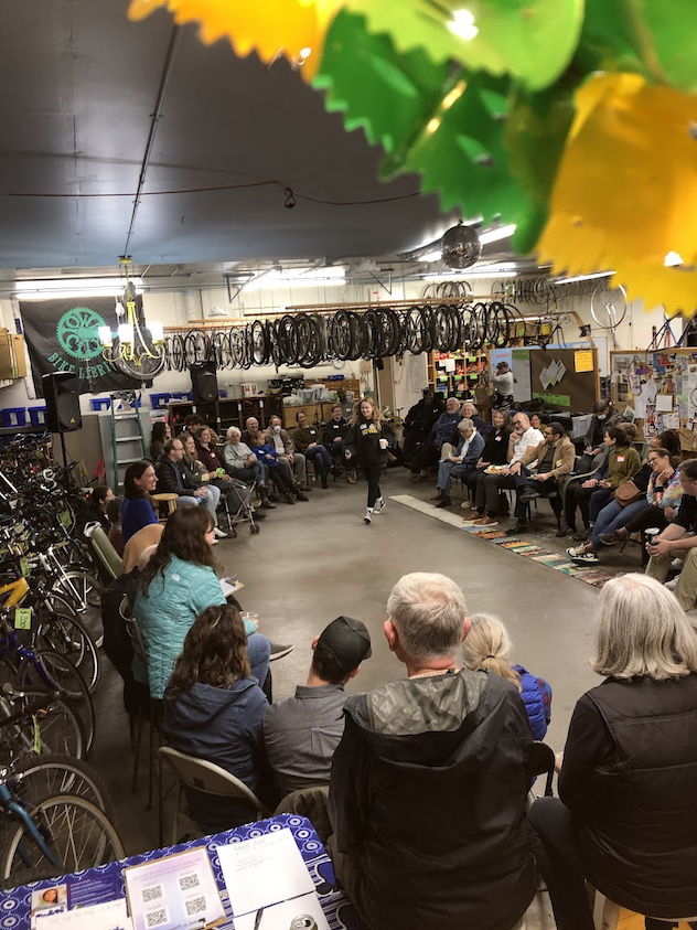 Folks in a circle at the Bike Library discussing important Iowa City topics.