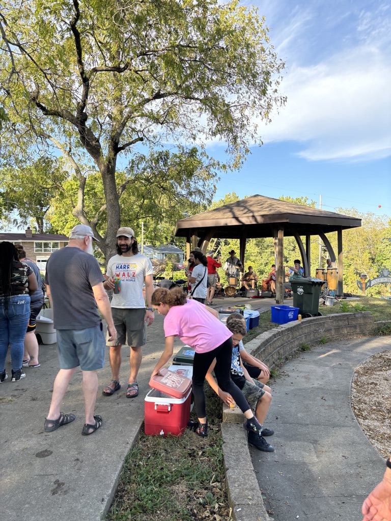 Neighbors talking at an outdoor music gathering