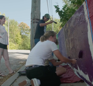 Neighbors paint a retaining wall